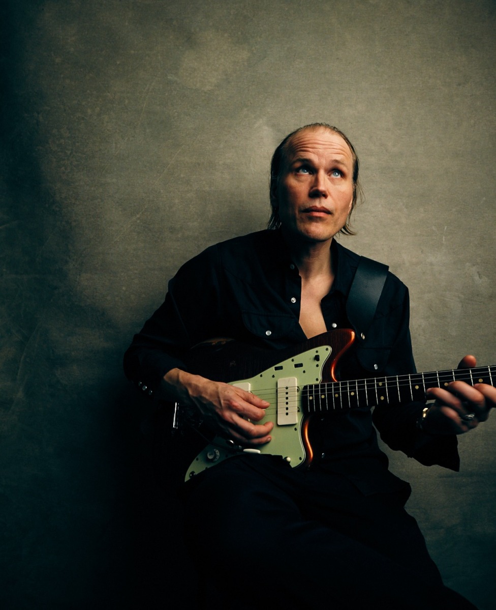Foto på Christian Kjellvander som spelar på en elgitarr